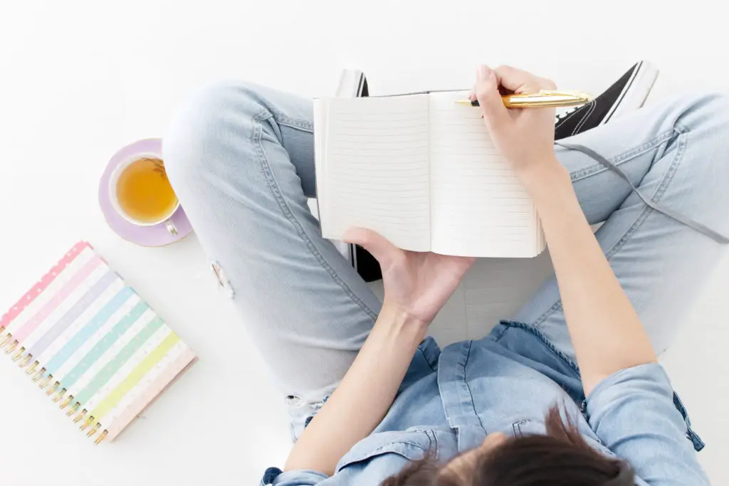 woman writing in a notebook