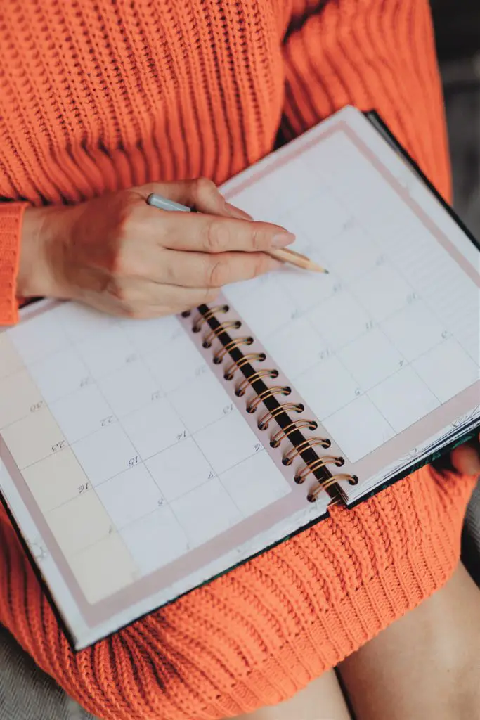 woman writing in a calendar