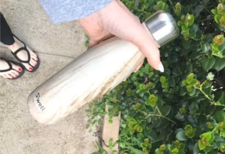 woman holding a reusable water bottle