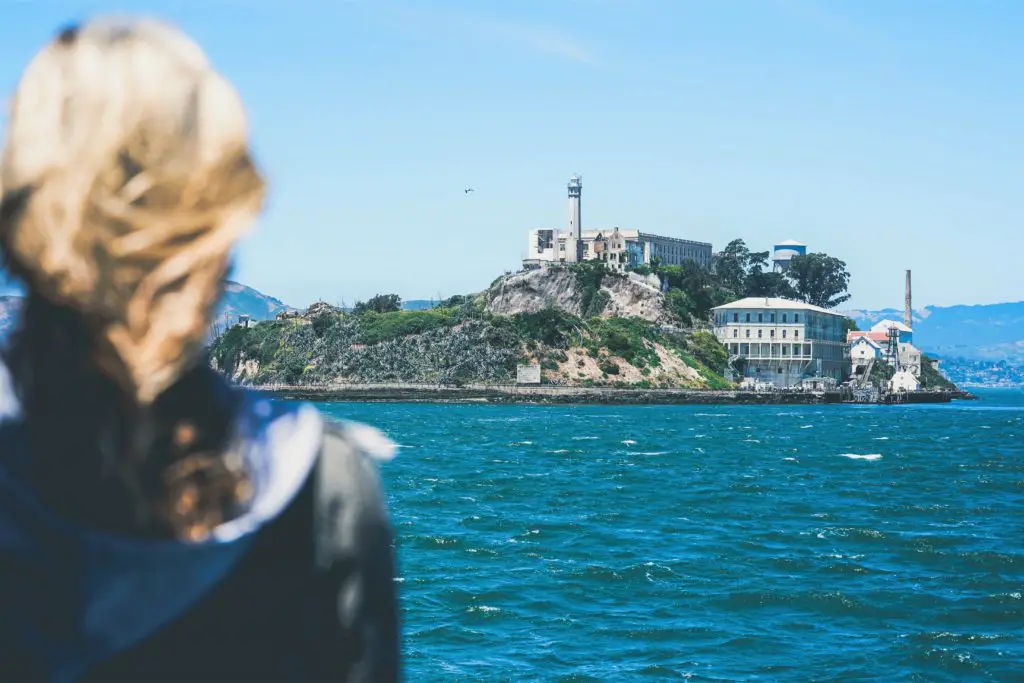 woman looking out at Alcatraz from San Francisco Bay
