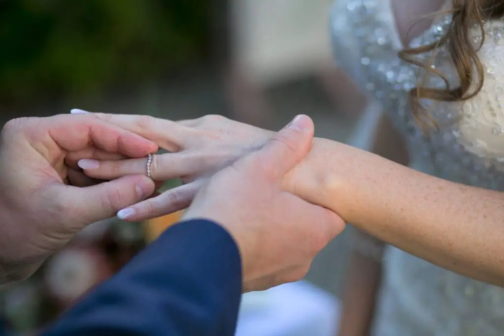 groom placing ring on brides finger