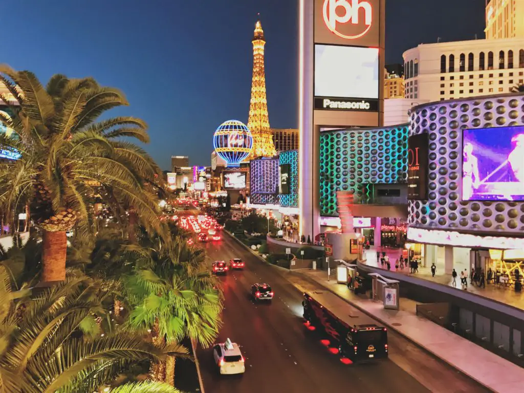 see the neon lights of the strip on a trip to las vegas