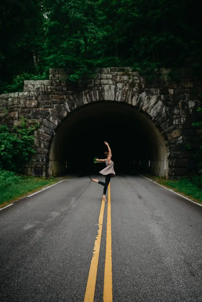 woman jumping in the middle of the road