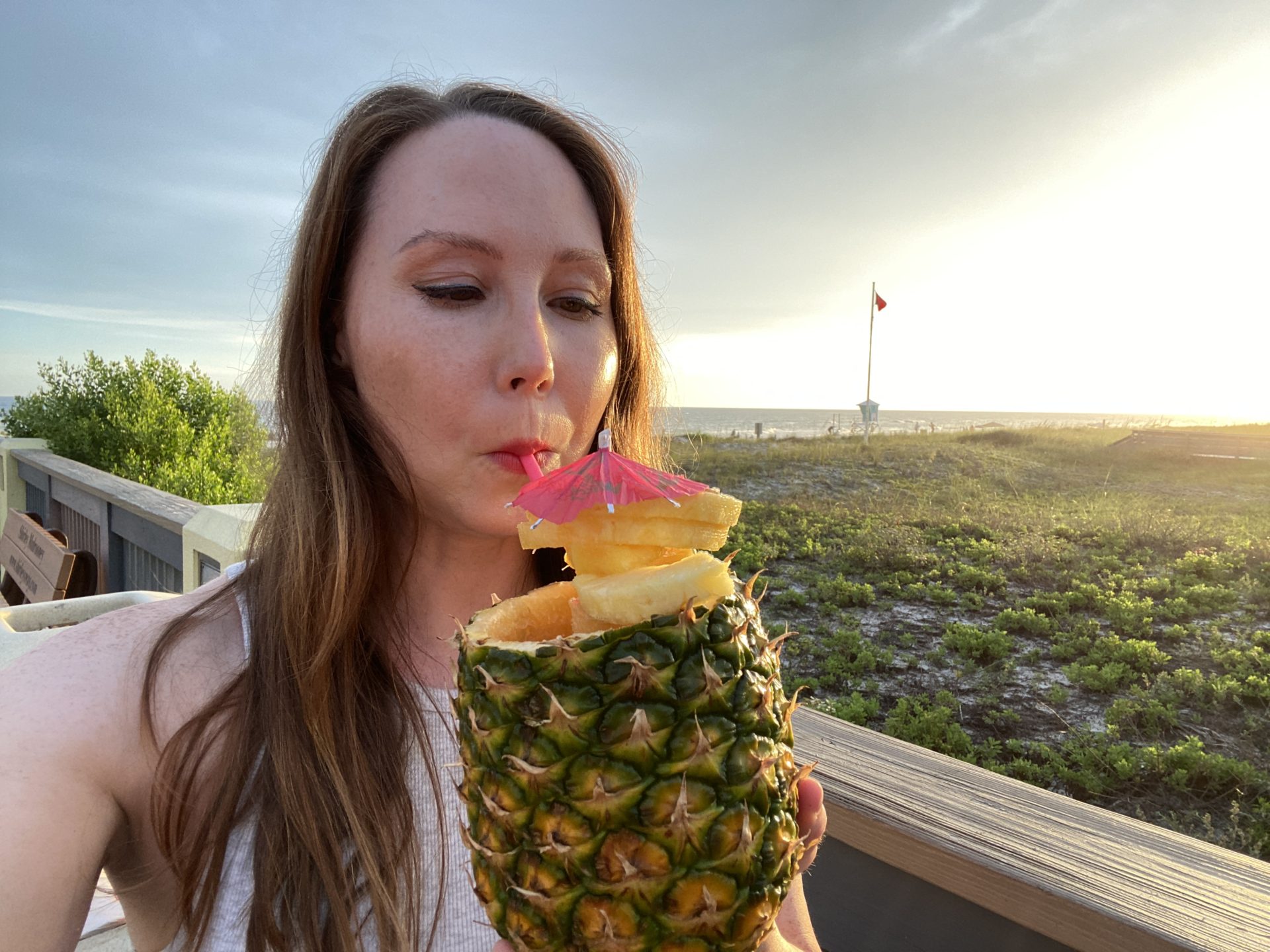 enjoying a pineapple drink near pier park in pcb