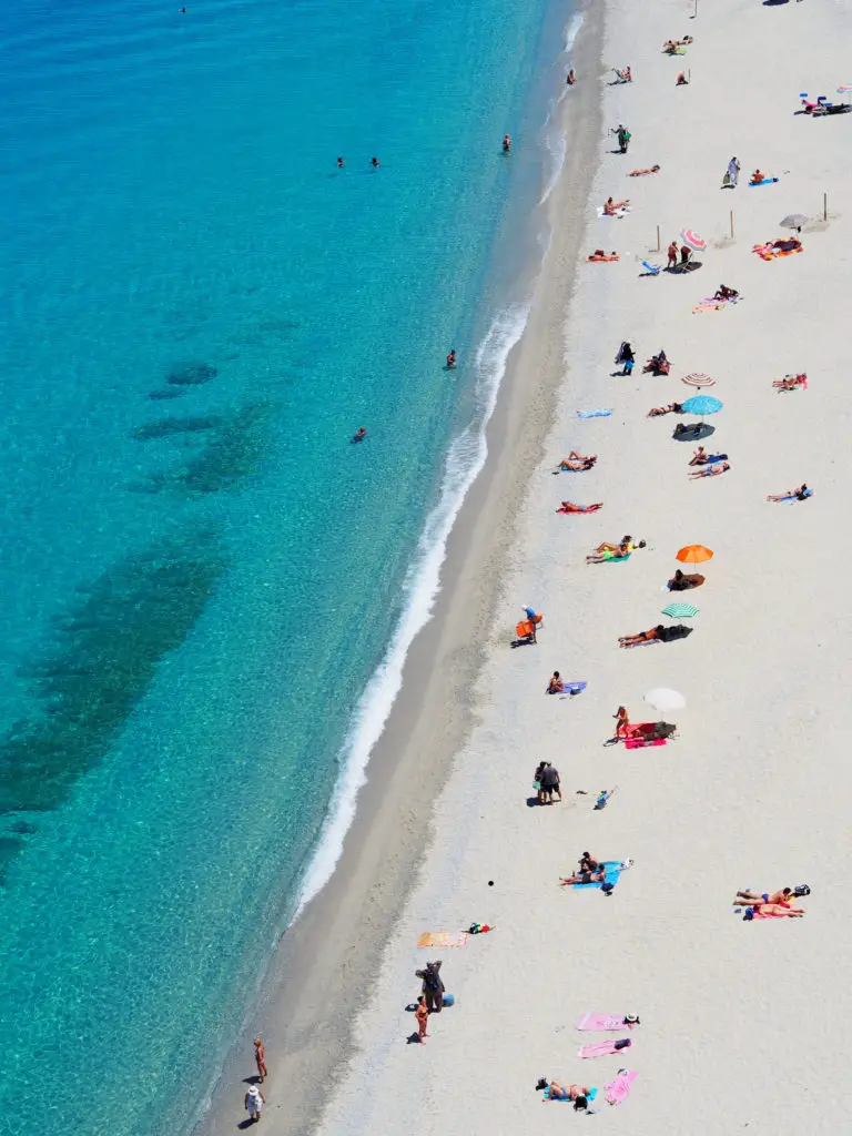 aerial view of people tanning at the beach